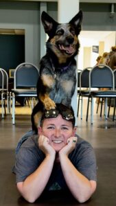 Trained dog calmly balancing on owner during reactive dog training session